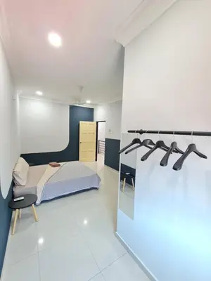 a bedroom with a bed and a blue wall at Air-home M9 Simpang near Aulong Econsave, 4BR, 10pax, Netflix in Taiping