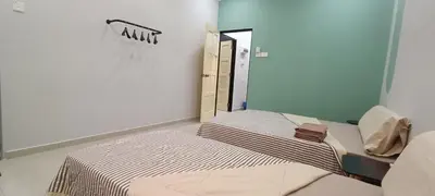 a small room with two beds and a mirror at Air-home M9 Simpang near Aulong Econsave, 4BR, 10pax, Netflix in Taiping