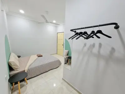 a small bedroom with a bed and a chair at Air-home M9 Simpang near Aulong Econsave, 4BR, 10pax, Netflix in Taiping