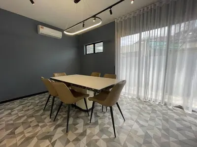 a dining room with a table and chairs in a room at 5000 SQFT BRAND NEW Semi-D Hype Home 10pax in Ipoh