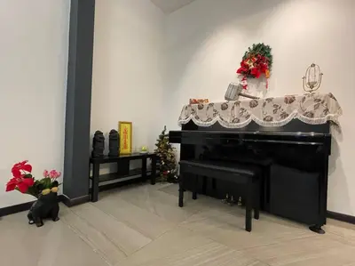 a black piano in a living room with christmas decorations at 5000 SQFT BRAND NEW Semi-D Hype Home 10pax in Ipoh