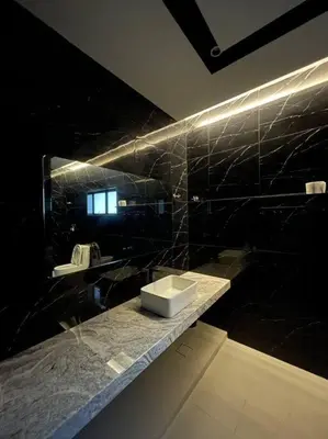 a black bathroom with a sink and a mirror at 5000 SQFT BRAND NEW Semi-D Hype Home 10pax in Ipoh
