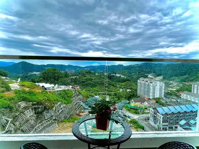 a view of a city from a balcony with a plant at Ammara homestay @ Palas Horizon kea Farm in Brinchang