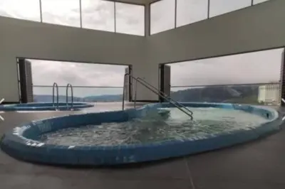 a hot tub in a building with windows at Ammara homestay @ Palas Horizon kea Farm in Brinchang