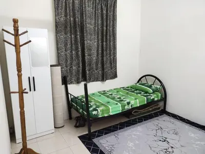 a room with a bed in a room with a curtain at Permai Homestay in Baling
