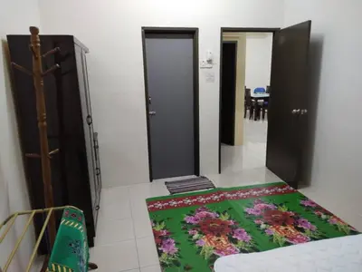 a room with two doors and a rug on the floor at Permai Homestay in Baling