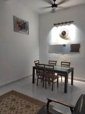 a dining room with a table and chairs at Kerian Putra Muslimstay in Parit Buntar