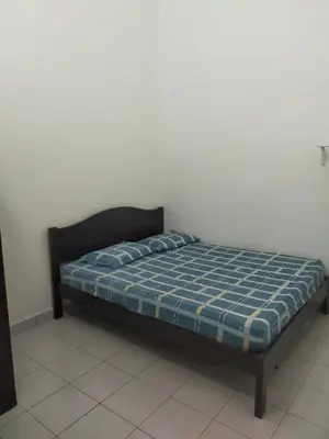 a bed in a room with a blue plaid mattress at Kerian Putra Muslimstay in Parit Buntar