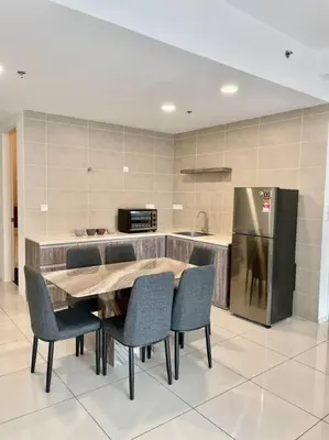 a kitchen with a table and chairs and a refrigerator at Onsen Suits HJM @ Sunway Ipoh in Ipoh