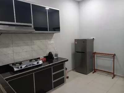 a kitchen with a stove and a refrigerator at Yaths homestay in Butterworth