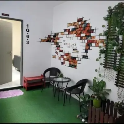a room with chairs and a wall with a bunch of books at My Chillex Homestay#Muslim Guest Only#3R 2B Apartment in Penang# in George Town