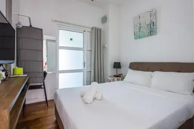 a bedroom with a bed with white towels on it at Nautilus Bay Home Inn in George Town