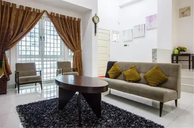 a living room with a couch and a table at Nautilus Bay Home Inn in George Town