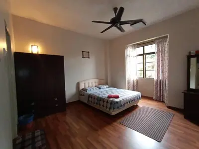 a bedroom with a bed and a ceiling fan at Aspen Holiday Apartment in Tanah Rata
