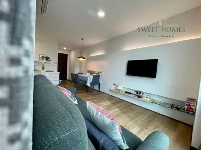 a living room with a couch and a flat screen tv at HolidayCozy StraitsGardenSuite Penang#6pax#family in George Town