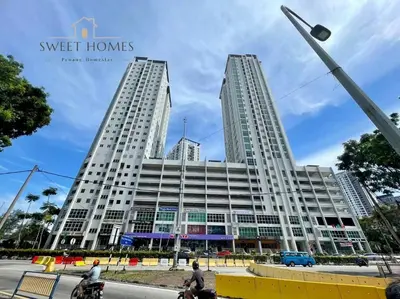 two tall buildings in a city with people on bikes at HolidayCozy StraitsGardenSuite Penang#6pax#family in George Town