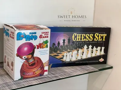 a chess set and a box on a shelf at HolidayCozy StraitsGardenSuite Penang#6pax#family in George Town