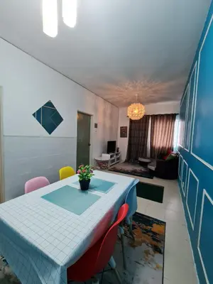 a dining room with a blue table and chairs at Amrich Staycation Muslim Cameron Highlands in Tanah Rata