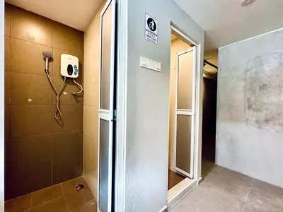 a shower in a bathroom with a phone on the wall at Armenian Guest House by LOLZ for 22pax in George Town