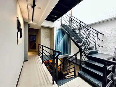 a staircase in a house with a black railing at Armenian Guest House by LOLZ for 22pax in George Town