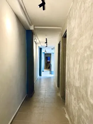 an empty hallway with a ceiling fan and a corridor at Armenian Guest House by LOLZ for 22pax in George Town