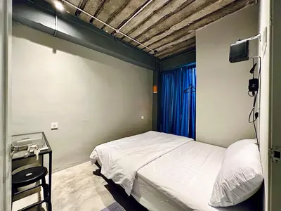 a small bedroom with a bed and a window at Armenian Guest House by LOLZ for 22pax in George Town