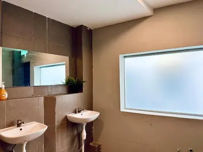a bathroom with two sinks and a window at Armenian Guest House by LOLZ for 22pax in George Town