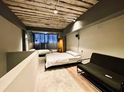 a bedroom with two beds and a couch in it at Armenian Guest House by LOLZ for 22pax in George Town