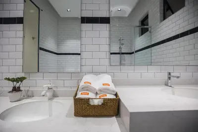 a bathroom with a tub with three folded towels at Carrot Seed in Ipoh