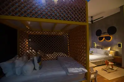 a bedroom with a bunk bed with mickey ears on the wall at Carrot Seed in Ipoh