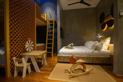 a bedroom with a bed and a bunk bed with a ladder at Carrot Seed in Ipoh