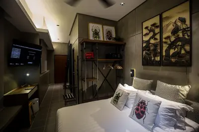a bedroom with a bed with white sheets and pillows at Carrot Seed in Ipoh