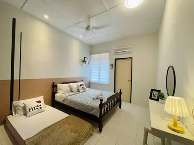 a bedroom with two beds and a table with a lamp at Ipoh 42 Symphony 12pax 4Bedroom 3bathroom 3carpark in Ipoh