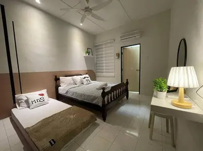a bedroom with two beds and a table with a lamp at Ipoh 42 Symphony 12pax 4Bedroom 3bathroom 3carpark in Ipoh
