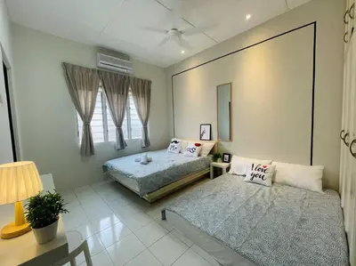a bedroom with two beds and a table with a lamp at Ipoh 42 Symphony 12pax 4Bedroom 3bathroom 3carpark in Ipoh
