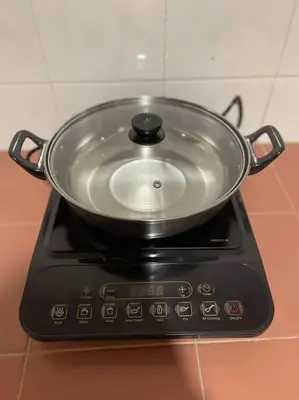 a pot sitting on top of a stove at Ipoh 42 Symphony 12pax 4Bedroom 3bathroom 3carpark in Ipoh