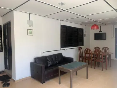 a living room with a couch and a table at Vintage Guesthouse in Tanah Rata