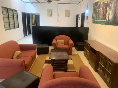 a waiting room with couches and chairs and a table at Vintage Guesthouse in Tanah Rata