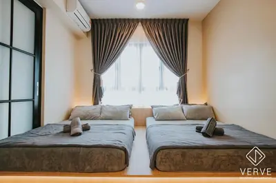 two beds in a room with a window at Ipoh Tambun Lost World Onsen by Verve in Tambun