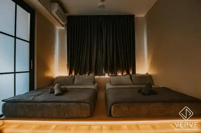 a bedroom with two beds in front of a window at Ipoh Tambun Lost World Onsen by Verve in Tambun