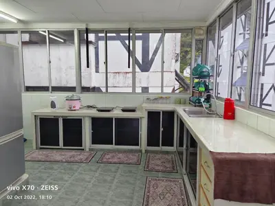 a kitchen with windows and a sink and a counter at Bani's Penthouse (Homestay Cameron Highlands) in Tanah Rata