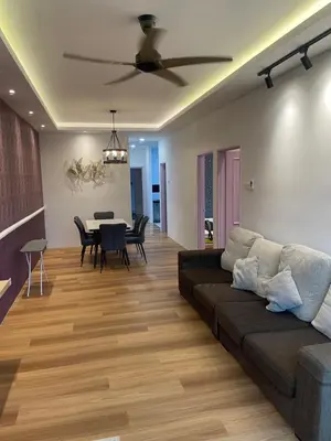 a living room with a couch and a table at Cameron Homestay Adik Aisyah Purple Romance for Islam in Tanah Rata