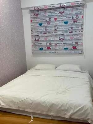 a bed in a room with a poster on the wall at Cameron Homestay Adik Aisyah Purple Romance for Islam in Tanah Rata