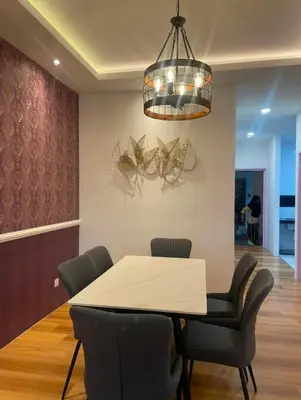 a dining room with a table and chairs and a chandelier at Cameron Homestay Adik Aisyah Purple Romance for Islam in Tanah Rata