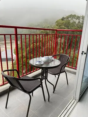 a table and two chairs on a balcony at Jo’s Place Cameron Highlands EA922 in Brinchang