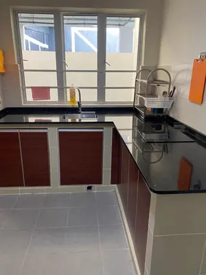 a kitchen with a counter with a sink and two windows at Jo’s Place Cameron Highlands EA922 in Brinchang