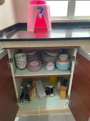 a kitchen shelf with plates and a pink mixer on it at Jo’s Place Cameron Highlands EA922 in Brinchang