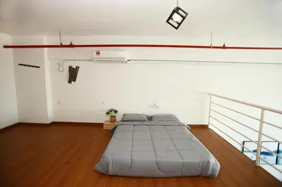 a bedroom with two beds in a room at Private 100 inches Screen Cinema at CEO Penang in Bayan Lepas