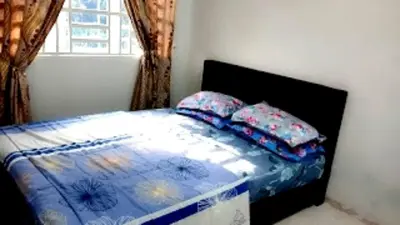 a bedroom with a bed with pillows and a window at Homestay Hafiy Manjung Lekir Sitiawan in Lekir