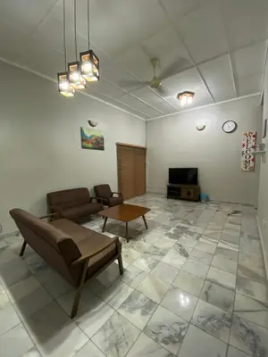 a living room with a couch and a tv at Nur Kasih Homestay Seri Manjung in Seri Manjung